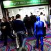 A man in a blue body suit walks into the North Hall during CES Saturday, Jan. 8, 2011, at the Las Vegas Convention Center.