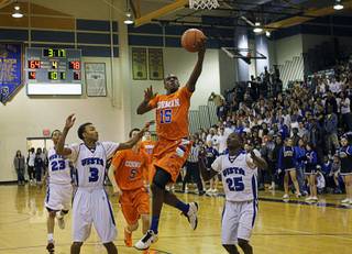 Shabazz Muhammad of Bishop Gorman High School lays up the ball against Sierra Vista High School defenders Gary Jacobs, left, and Maiscei Grier during a game at Sierra Vista  Monday, January 10, 2011.