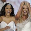 Miss Nebraska Teresa Scanlan, right, 17, reacts after being announced 2011 Miss America during the Miss America Pageant at the Theater for the Performing Arts in Planet Hollywood on Jan. 15, 2011. 2010 Miss America Caressa Cameron prepares to crown her.