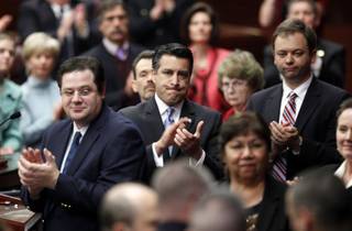 Gov. Brian Sandoval, center, leads a standing ovation for a pair of Nevada servicemen who were decorated for their actions in Afghanistan, while making his first State of the State address before a joint session of the Nevada Legislature in Carson City on Monday, Jan. 24, 2011. Lt. Col Tony Millican, who is stationed at Nellis Air Force Base, received the Bronze Star and the Air Force's Lance P. Sijan Award for heroism. Spl. Ernesto Padilla, of the Nevada National Guard received the Purple Heart for wounds he suffered from a road side blast that tore his vehicle in half. 