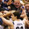 Photo: BYU guard Jimmer Fredette is mobbed by students af Photo: BYU guard Jimmer Fredette is mobbed by students af