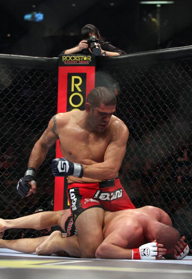 Antonio Silva, top, of Brazil, punches Fedor Emelianenko, of Russia, during a Strikeforce Heavyweight Grand Prix fight on Saturday, Feb. 12, 2011 at the Izod Center in East Rutherford, N.J. Silva won after the end of the second round when the doctor said Emelianenko could no longer see out of his eye.