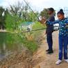 Photo: Cristen fishes while his sister Kelijah tries to u Photo: Cristen fishes while his sister Kelijah tries to u