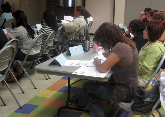 Students listen and take notes during the Hispanic Citizens Academy at the Pearson Community Center. Metro Police launched the Spanish-speaking program in September 2007 and now are training North Las Vegas Police to launch their own program. Any Hispanic citizens, regardless of legal status, can attend the Hispanic Citizens Academy, which aims to inform them of their rights and promote crime-fighting awareness.
