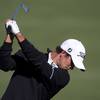 Former UNLV golfer Adam Scott hits balls on the practice range as he prepares for the final round Masters golf tournament at the Augusta National Golf Club in Augusta, Ga., on Sunday, April 3, 2011. 