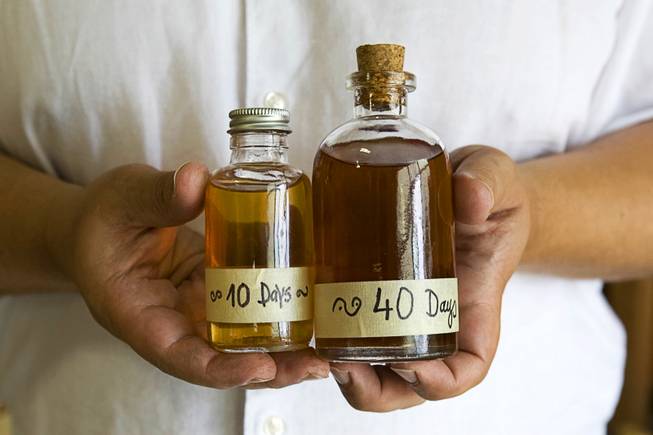 George Racz displays samples of whiskey at the Las Vegas Distillery in Henderson July 5, 2011. The business will hold an official grand opening July 22. From July 8 until then, customers can bottle their own Nevada Vodka but they must pick up the bottles from a retail store at a later date, Racz said.