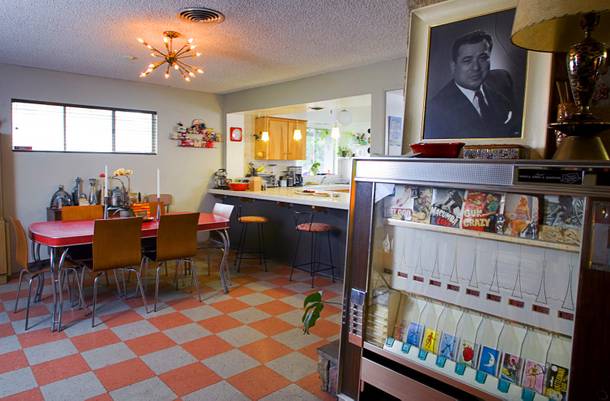 The dining room is shown in the home of Courtney Mooney and Josh Rogers Sunday, July 31, 2011. At right is an old cigarette vending machine. At top right is a portrait of Jack Cortez who used to publish
