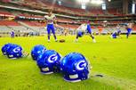 New Bishop Gorman football helmets are seen on the ground as the Gaels warm up for their game against the Chaparral Firebirds at the Sollenberger Classic on Saturday, Aug. 20, 2011, at University of Phoenix Stadium in Glendale.