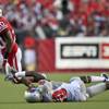 Wisconsin running back James White, left, runs for first down against UNVL's Kenny Brown during the first half of an NCAA college football game, Thursday, Sept. 1, 2011, in Madison, Wis.