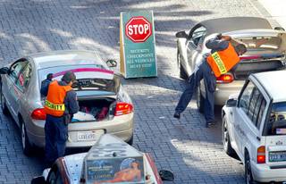Security officers at the Venetian check cars entering the property Sunday, Feb. 9, 2003. Many casinos around the valley stepped up on security after U.S. officials elevated the national terrorism alert to the second highest level.