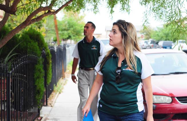 Mojave High School Principal Antonio Rael (back) and Dean of Students Nathalie Burgess (front) look for an at-risk, "non-returning" student's home during the Clark County School District's "Reclaim Your Future" event on Saturday, Sept. 10, 2011. The volunteer event encourages at-risk, "non-returning" students to come back to school and graduate.