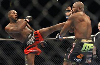 Jon Jones, left, of Endicott, N.Y., gets in a kick to the head of Rampage Jackson, of Irvine, Calif., during the first round of their UFC light heavyweight title bout, Saturday, Sept. 24, 2011, in Denver.