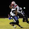 Photo: Liberty running back Niko Kapeli leaps over Basic Photo: Liberty running back Niko Kapeli leaps over Basic