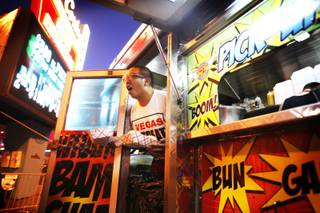 Luis Mora calls out an order at the Slidin' Thru truck during Vegas Streats in downtown Las Vegas on Saturday, Oct. 8, 2011.