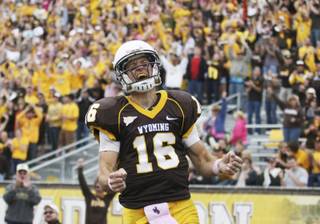 Wyoming quarterback Brett Smith celebrates his touchdown catch on a trick play during an NCAA college football game against UNLV on Saturday, Oct. 15, 2011, at War Memorial Stadium in Laramie, Wyo.