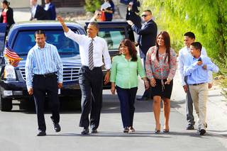 President Barack Obama walks with, from left, Jose Bonilla, Lissette Bonilla and their children Margarita Bonilla, Franco Bonilla and Mario Bonilla before Obama spoke about the American Jobs Act on Oct. 24, 2011, in Las Vegas. Obama also announced a housing initiative to help homeowners with federally guaranteed mortgages refinance their homes.