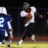 Photo: Las Vegas quarterback Hasaan Henderson looks for a Photo: Las Vegas quarterback Hasaan Henderson looks for a