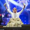 Pius Heinz of Germany holds up stacks of cash after defeating Martin Staszko of the Czech Republic to win the championship bracelet and $8.7 million in first-place prize money during the World Series of Poker Main Event early Wednesday morning, Nov. 9, 2011, at the Rio. In the background are 2010 winner Jonathan Duhamel and ESPN reporter Kara Scott.