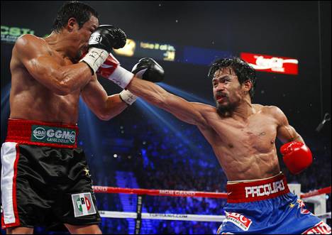 Manny Pacquiao, right, of the Philippines punches at Juan Manuel Marquez of Mexico during their WBO welterweight fight at the MGM Grand Garden Arena Saturday, Nov. 12, 2011. Pacquiao won the 12-round fight by majority decision.