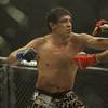 Photo: Gilbert Melendez throws a punch at Josh Thomson du