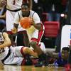 Photo: UNLV guard Reggie Smith picks up a loose ball agai