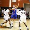 Gio Guzman, center, of Bishop Gorman passes the ball as Sir Washington, left, and Kentrell Washington of Clark defend during their game at Clark High School in Las Vegas Friday, Jan. 13, 2012. Bishop Gorman took the game 80-68.