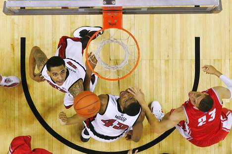 UNLV's Anthony Marshall, left, and Mike Moser wait for a rebound with New Mexico guard Phillip McDonald during their Mountain West Conference game Saturday, Jan. 21, 2012 at the Thomas & Mack Center. UNLV won the game 80-63.