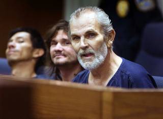 Tony McNeill, 54, appears in Henderson Justice Court on Monday, Jan. 23, 2012. McNeill, who faces felony charges for pointing a rifle at officers, has been recovering in the hospital after having been shot by Henderson Police in late December.
