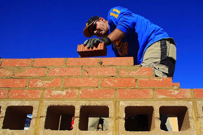 Dave Jones Sr. lays down a course of bricks during the Spec Mix Bricklayer 500 contest Wednesday, Jan. 25, 2012 being held in conjunction with the World of Concrete convention.