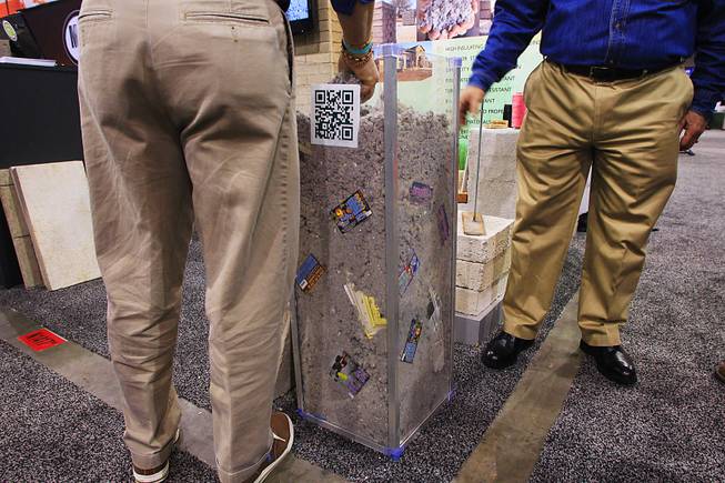 Attendees check out the admixture at the Green Blox booth during the World of Concrete convention Wednesday, Jan. 25, 2012.