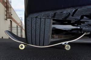 A car rests on a Colonial Brand skateboard at the ...