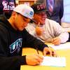 Liberty High School's Jared Tuilagi (near) and P.J. Taeao signing letter of intent Feb. 1, 2012 on national signing day. Tuilagi signed with North Dakota and Taeao signed with Southern Utah.