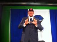 Desert Pines High School offensive tackle Cedrick Poutasi holds up the University of Utah 'U' after signing a national letter of intent on Feb. 1, 2012.
