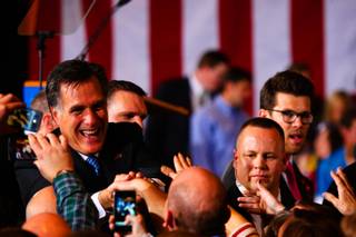 Surrounded by U.S. secret service agents, Republican presidential candidate Mitt Romney shakes hands with supporters at the Nevada Republican caucus Saturday, Feb. 4, 2012, at the Red Rock Hotel and Casino in Las Vegas.