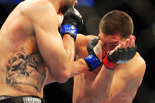 Carlos Condit hits Nick Diaz with a left during their interim welterweight championship bout Saturday, Feb. 4, 2012 at the Mandalay Bay Events Center. Condit won a unanimous decision and will likely face Georges St. Pierre in November.