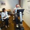 Dean Bengert rides a stationary bicycle at the Cleveland Clinic Lou Ruvo Center for Brain Health Monday, February 6, 2012. Kathy Nagle, a research nurse coordinator, keeps notes at left. Bengert, 52, is participating in a clinical trial that is studying the effect of exercise on patients with Parkinson's disease.