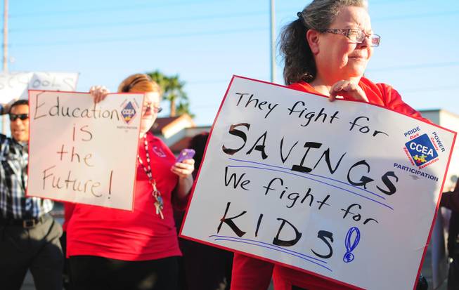 Brinley Middle School teacher Deenene Armstrong holds up a sign during a teachers union rally at the Clark County School District administration building on Wednesday, Feb. 8, 2012. About 100 teachers rallied at the West Sahara building to protest potential layoffs and working conditions.