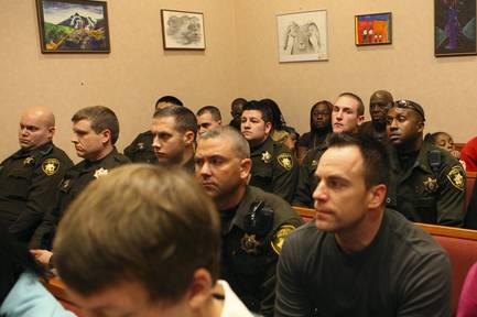 Metro Police officers sit in a North Las Vegas courtroom during the arraignment Dec. 2, 2009, of six alleged gang members charged in connection with the slaying of Metro Police Officer Trevor Nettleton.