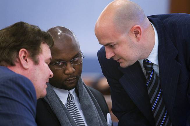Benjamin Gerard Hawkins, center, confers with attorneys James Kelly, left, and Jack Buchanan during a preliminary hearing in District Court Tuesday Feb. 28, 2012. Hawkins, a Gainesville, Fla., teacher who was on vacation, is facing charges of involuntary manslaughter in connection with the death of another tourist after an altercation at O'Sheas in July.