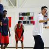 Findlay Prep head coach Michael Peck, right, gives advice to players during practice at the Henderson International School campus Monday, March 26 2012.