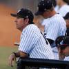 UNLV baseball assistant coach Kevin Higgins, left, watches play from the dugout during UNLV's game against Southern Utah at Wilson Stadium Tuesday, March 27, 2012.   