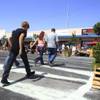 Photo: People cross the street towards the Greener Block Photo: People cross the street towards the Greener Block