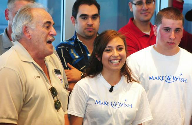 Vanessa (center) smiles as Larry Gareffa, president of Mustang and Classic Ford Club Las Vegas, talks about the various efforts it took to make Vanessa's wish for a refurbished 1967 Ford Mustang coupe come true on Saturday, April 28, 2012. The 17-year-old Centennial High School senior, who was born with a congenital heart condition, was the recipient of a car makeover courtesy of the local Make-A-Wish Foundation and its partners.