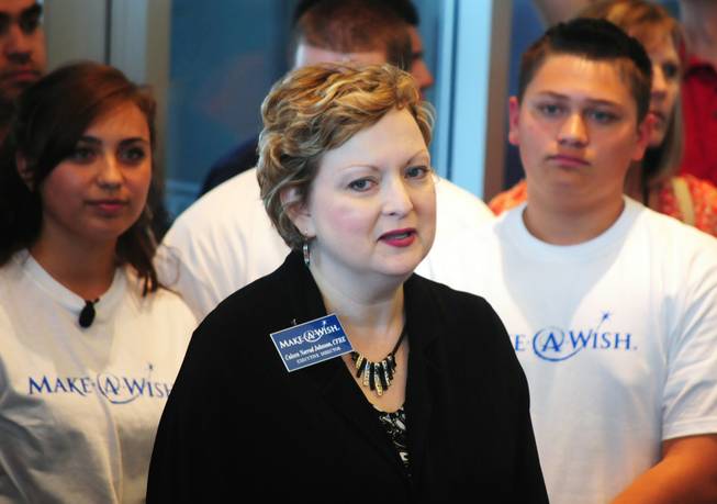 Make-A-Wish Foundation of Southern Nevada's Executive Director Caleen Norrod Johnson speaks as Vanessa (top-left) looks on on Saturday, April 28, 2012. The 17-year-old Centennial High School senior, who was born with a congenital heart condition, was the recipient of a car makeover courtesy of the local Make-A-Wish Foundation and its partners.