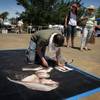 Donovan Fitzgerald, 24, works on his sidewalk chalk composition at the Art Festival of Henderson on Saturday, May 12, 2012. About 50
contestants are participating in the event this year.