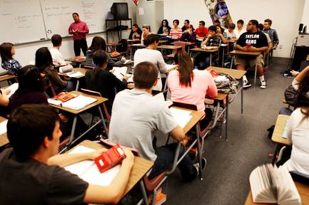 In this May 11, 2011, file photo, Arthur Gamboa leads a discussion with students in his Modern Literature class at Palo Verde High School. The School District has announced plans to lay off 1,015 teachers and literacy specialists.