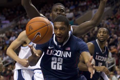 Connecticut Huskies forward Roscoe Smith (22) looks to regain control of the ball with Villanova Wildcats forward/center Mouphtaou Yarou (13) looming behind him during the NCAA Basketball game between the Connecticut Huskies and the Villanova Wildcats on Feb. 20, 2012, at the Wells Fargo Center in Philadelphia. Connecticut beat Villanova 73-70 in overtime.