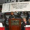 Manny Pacquiao reacts as undefeated Timothy Bradley Jr. holds an oversized ticket to a rematch during a news conference at MGM Grand on Wednesday, June 6, 2012. Manny Pacquiao reacts as undefeated Timothy Bradley Jr. holds an oversized ticket to a rematch during a news conference at MGM Grand on Wednesday, June 6, 2012.