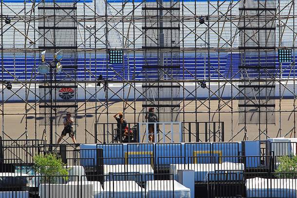Workers put together the final touches for the Electric Daisy Carnival Thursday, June 7, 2012 at the Las Vegas Motor Speedway.