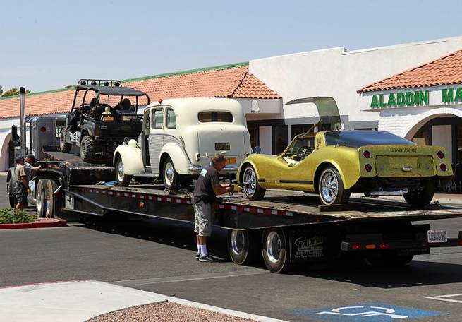 An HBO crew secures cars, once owned by Liberace, onto a car carrier at the Liberace Museum parking lot, Wednesday July 11, 2012. The cars, a 1972 custom Bradley GT and a 1957 London taxi, are on loan to HBO for a project titled "Behind the Candelabra," an official said.